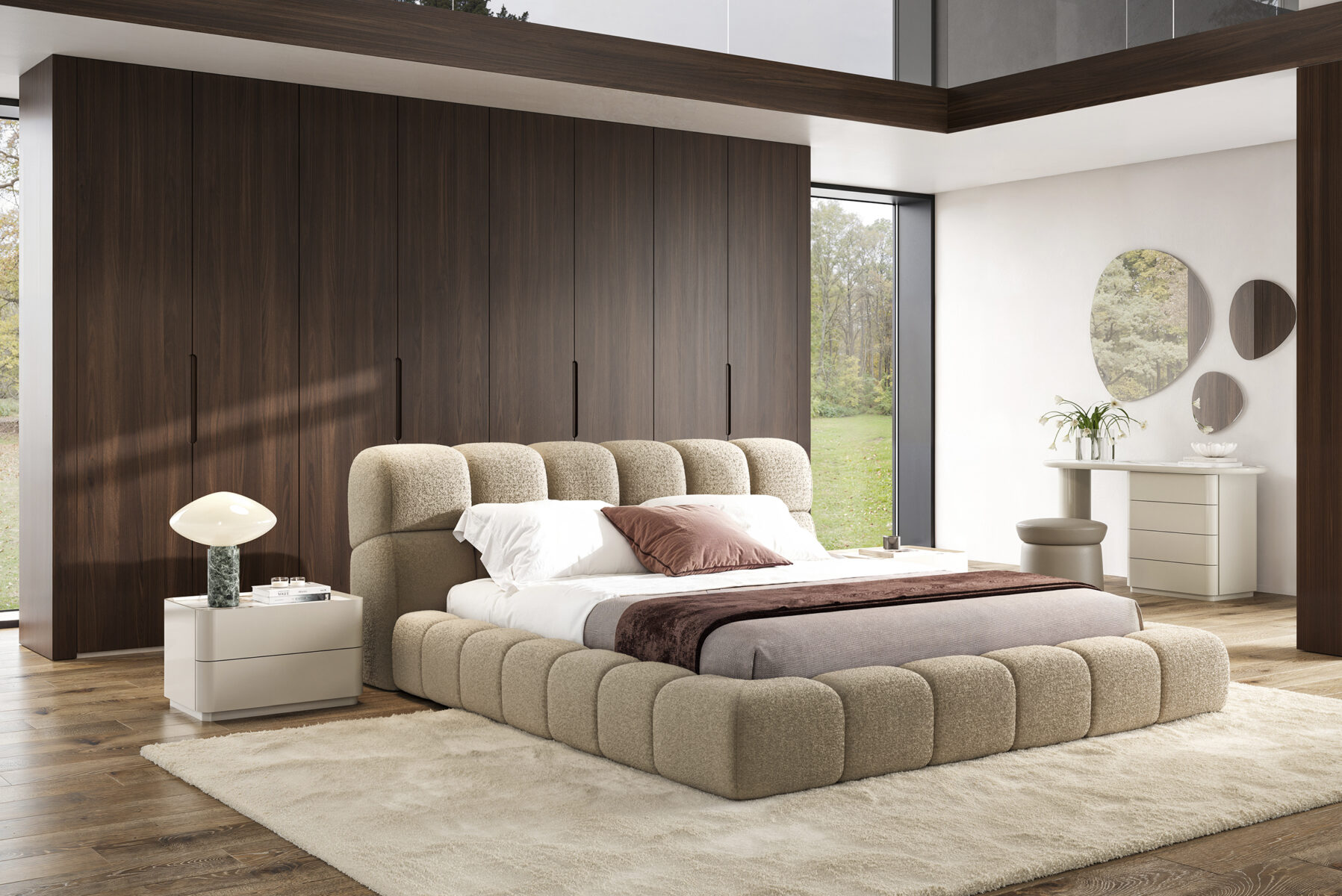 Contemporary bedroom featuring a plush beige bed with a curved headboard, wooden wall paneling, and minimalist decor including a white dresser and round wall mirrors.