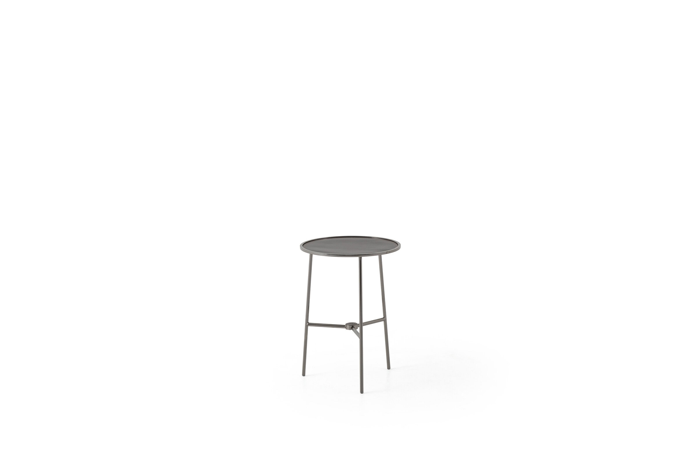 Contemporary round side table with metal legs and a dark tabletop, ideal for modern living spaces, from Saloni Furniture.