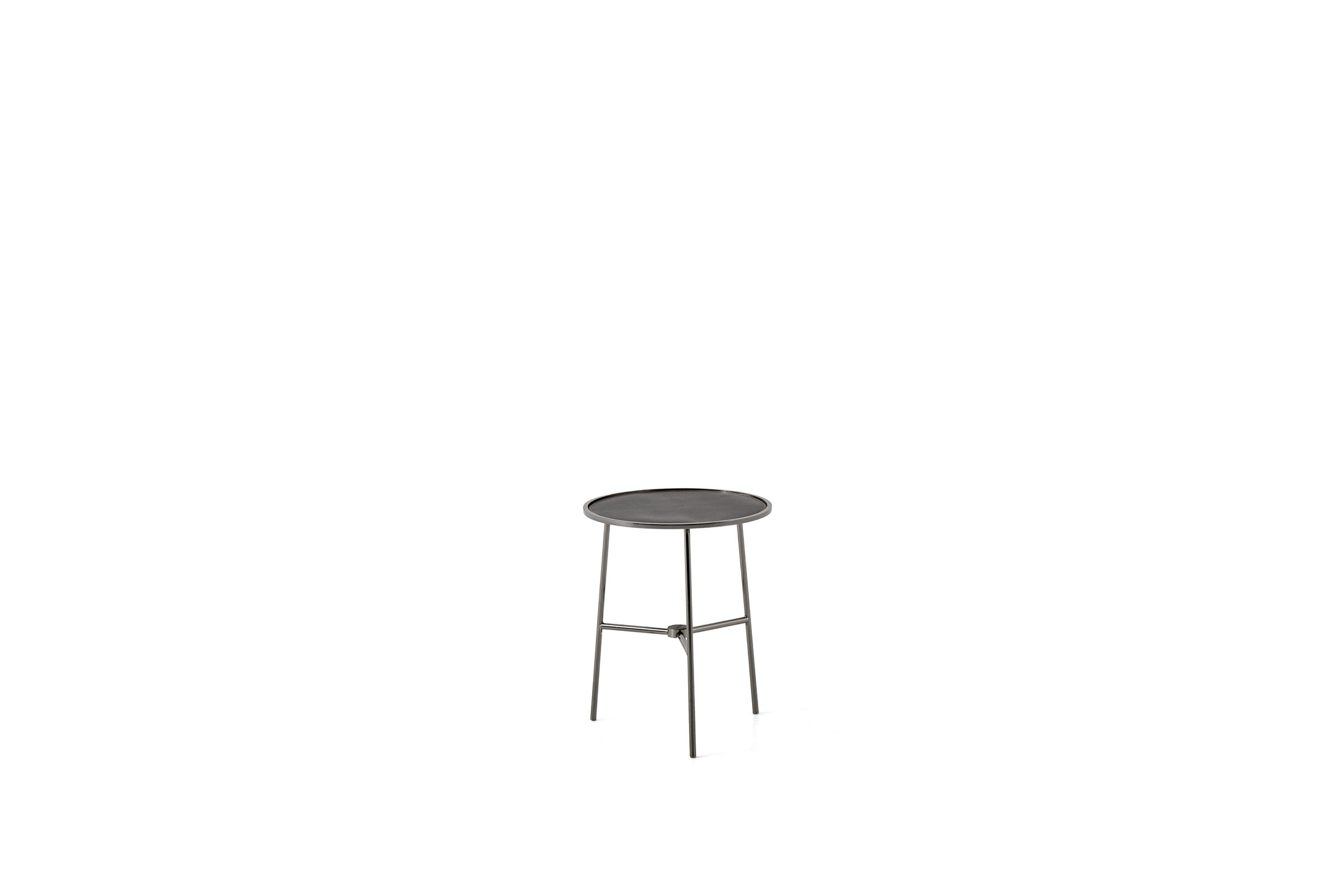 Sleek metal side table with round top and minimalist design, ideal for contemporary living spaces.