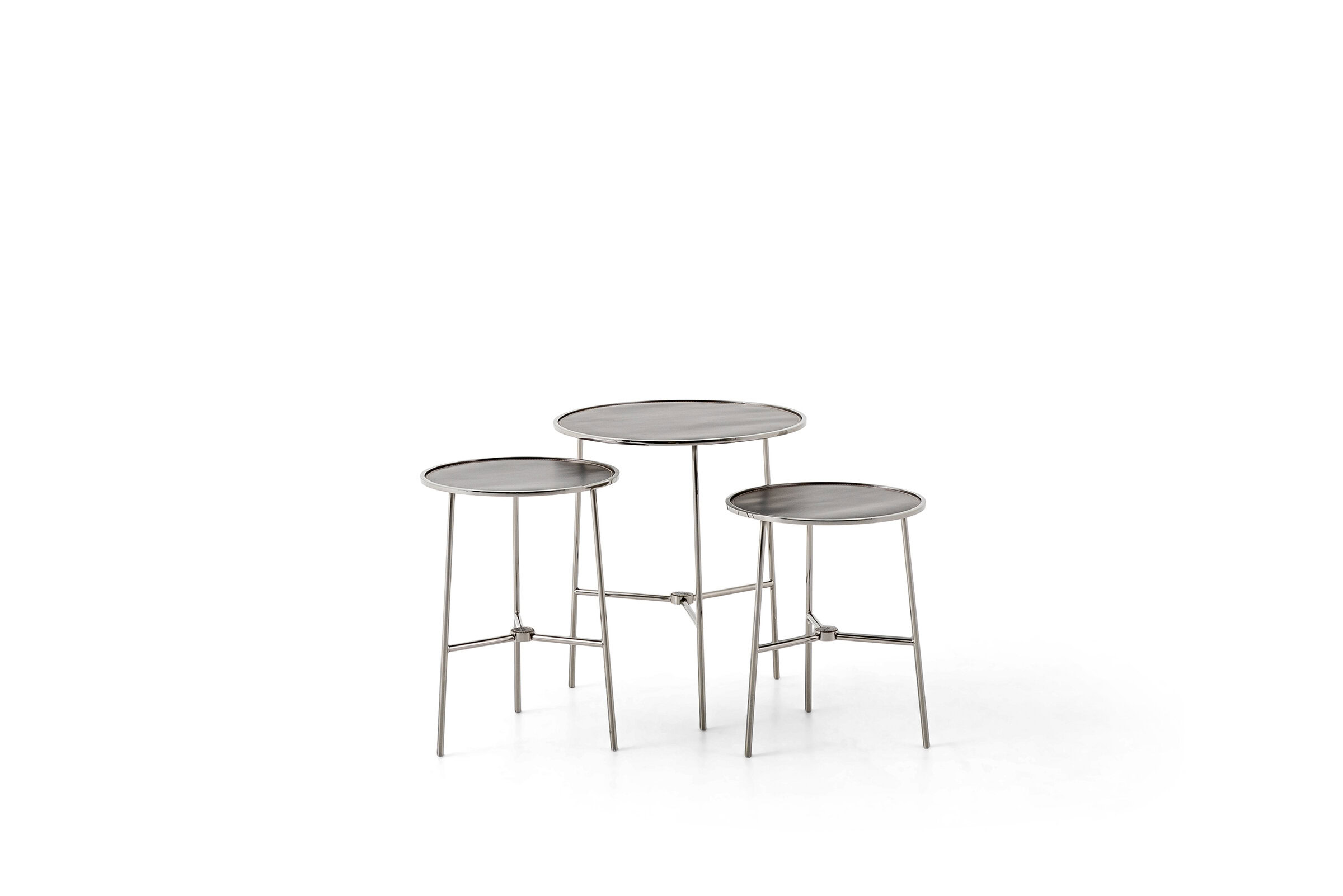Set of three modern metal nesting tables with round tabletops and sleek legs, ideal for contemporary living room decor.