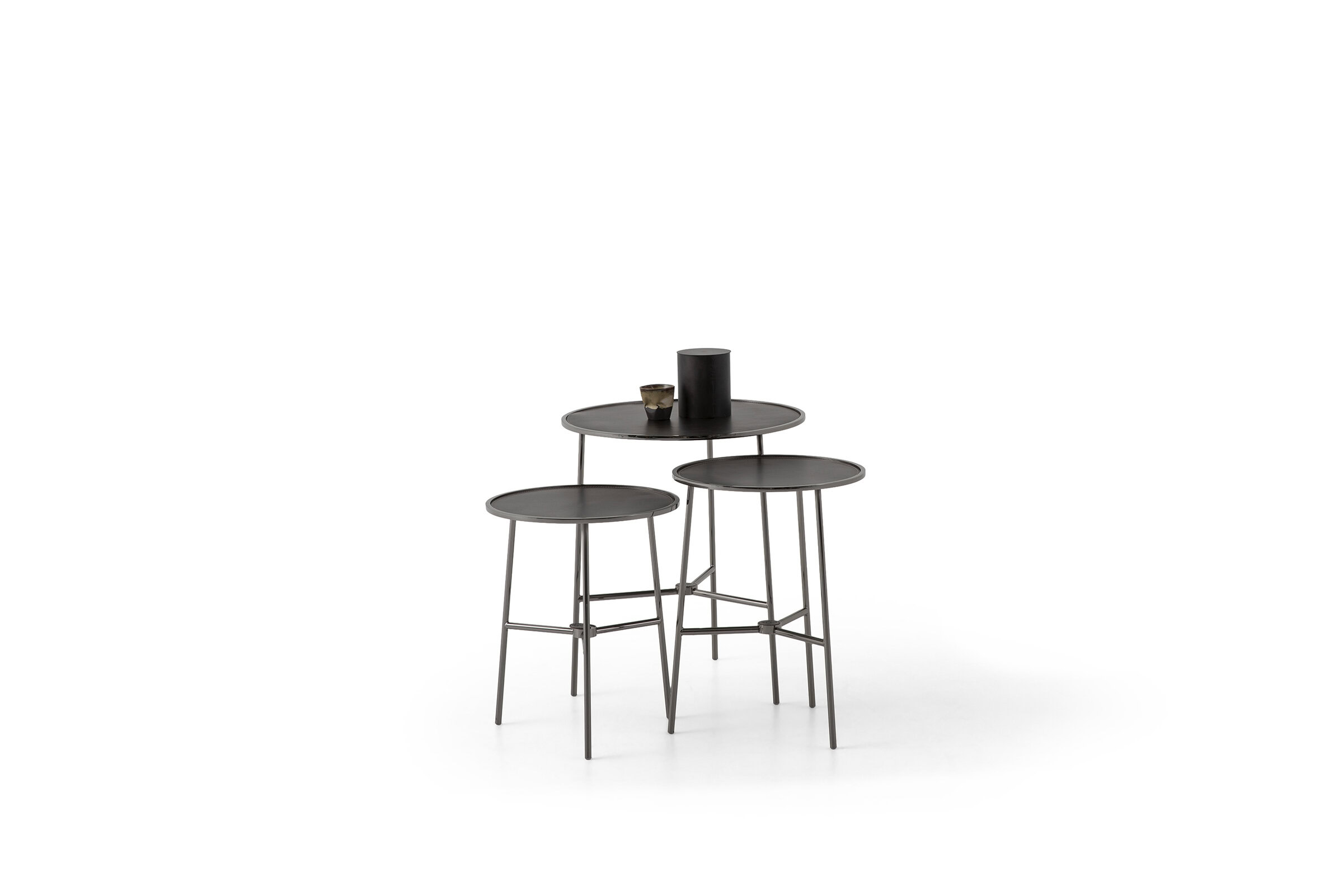 Set of three modern black nesting tables with metal legs and round tabletops, ideal for contemporary living room decor from Saloni Furniture.