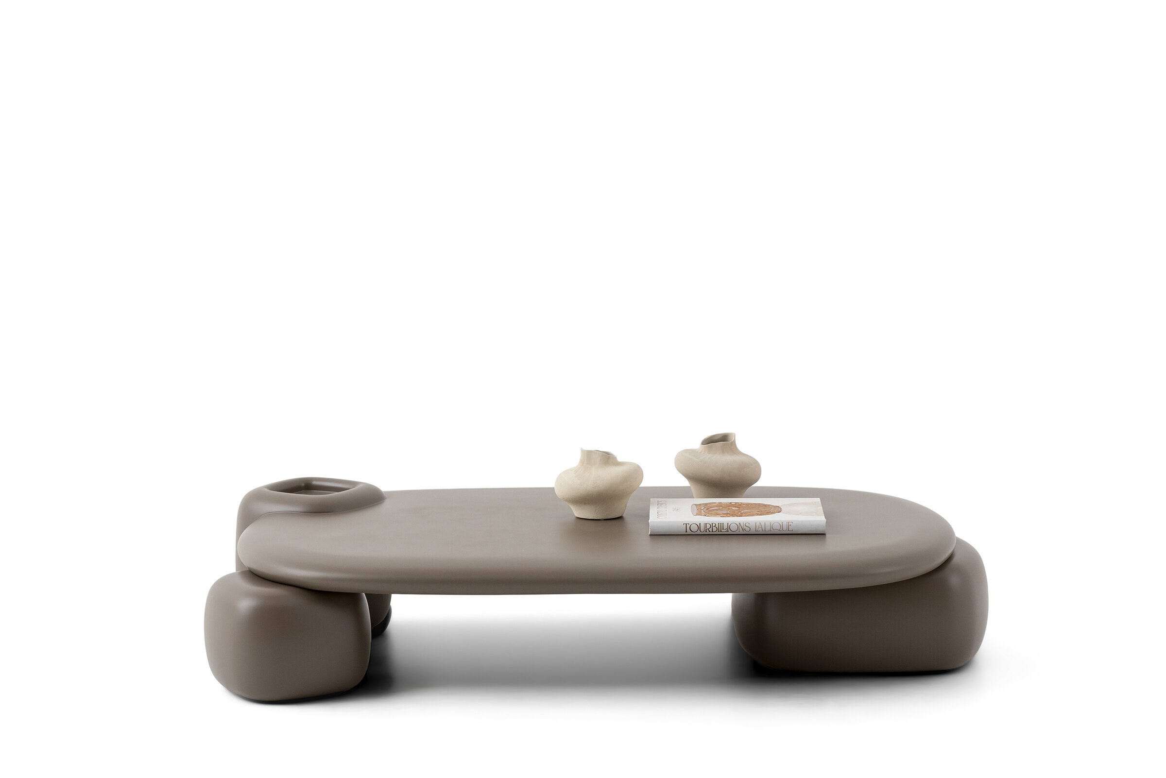 Elegant beige minimalist coffee table with smooth rounded edges and decorative accessories, perfect for contemporary living rooms.
