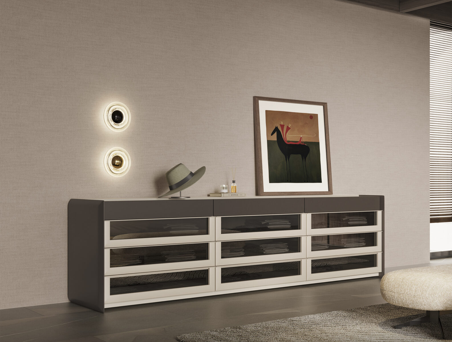 Sleek modern sideboard with glass-front drawers in black and white, placed against a textured beige wall with contemporary wall lights, topped with decorative accessories and artwork.