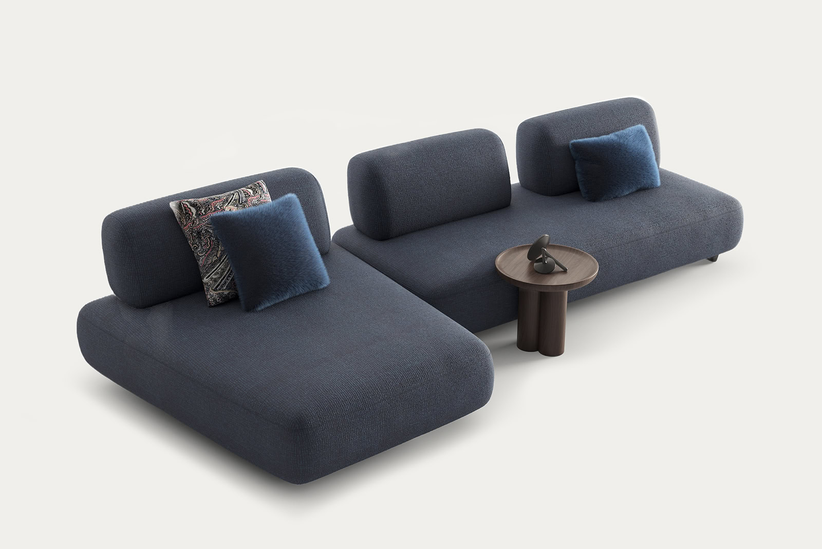 Contemporary blue sectional sofa with matching cushions and a small wooden side table, ideal for modern living room decor.