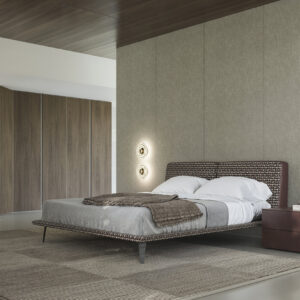 Luxurious modern bedroom with a stylish upholstered bed, sleek bedside table, and minimalist decor showcasing contemporary furniture design.