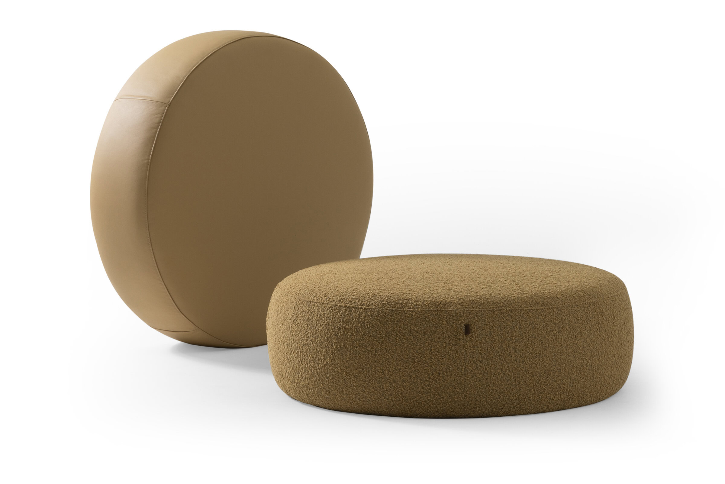 Luxurious modern round ottomans with plush fabric and smooth leather upholstery, perfect for contemporary living room decor and stylish seating arrangements.
