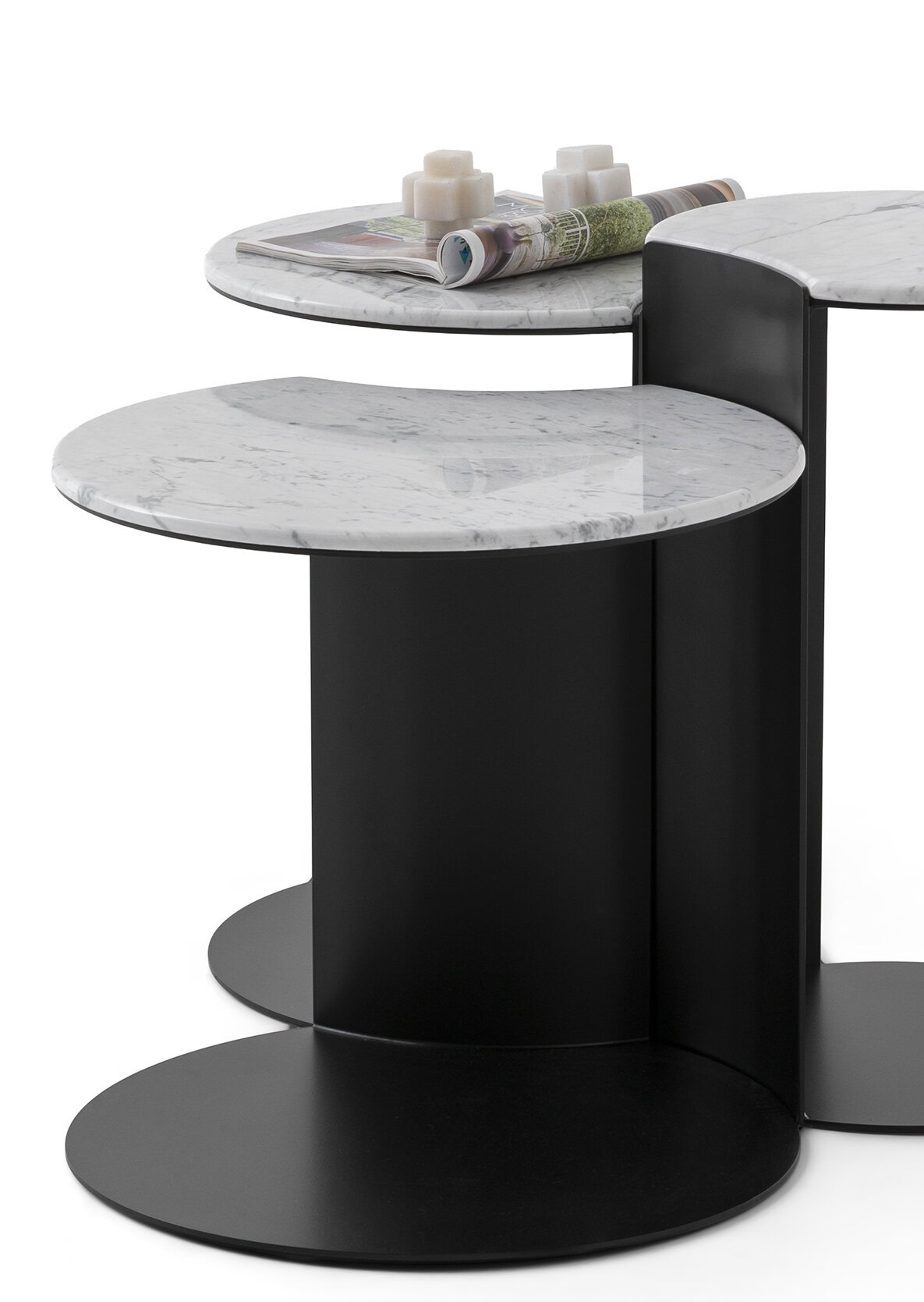 Set of stylish modern side tables with marble tops and black bases, ideal for contemporary living room decor.