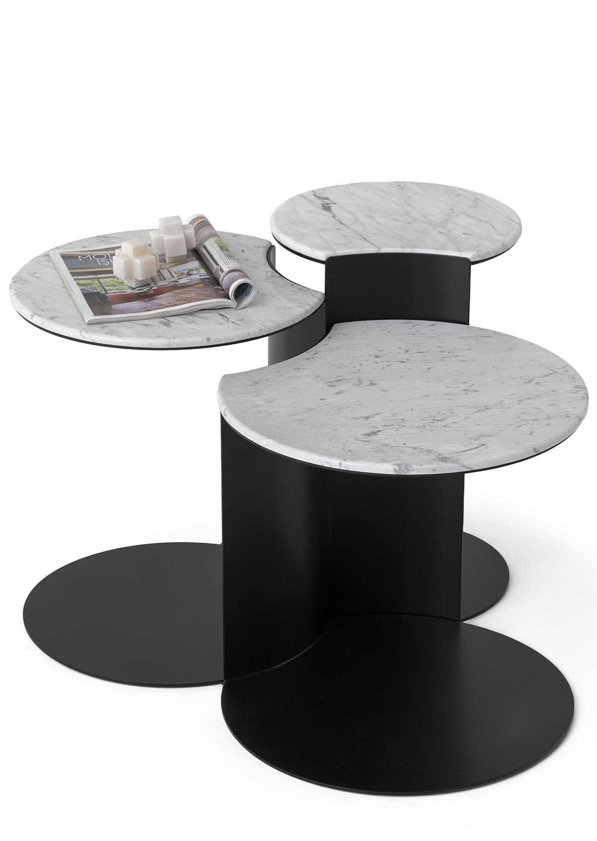 Set of three modern side tables with white marble tops and black bases, stylish and versatile for contemporary living spaces.