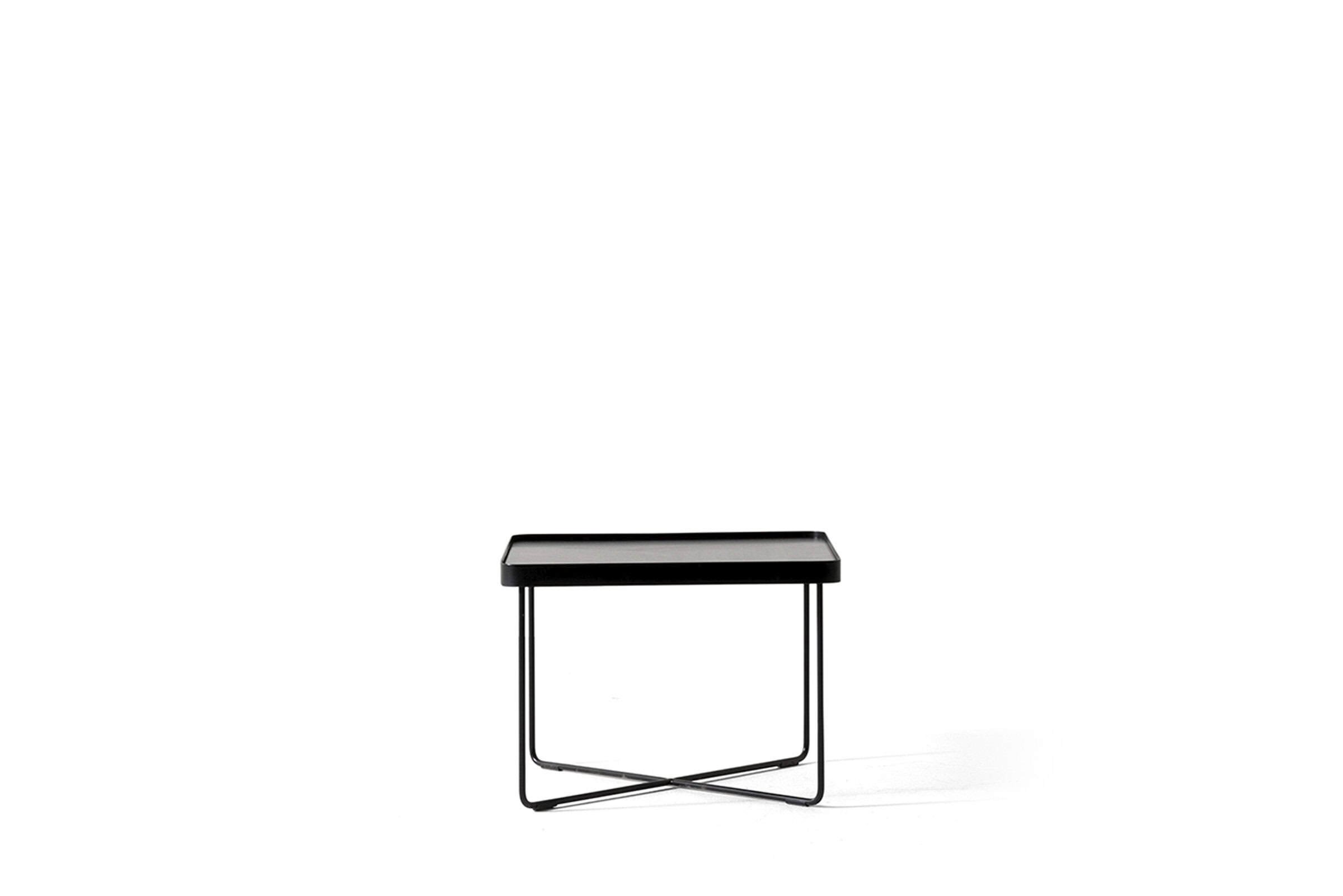 Sleek black side table with minimalist metal frame, modern design, perfect for home or office decor. Suitable for accent, bedside, or next to a sofa for stylish functionality.