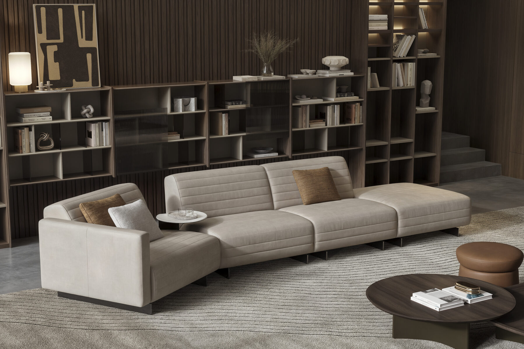 Elegant modern beige sofa with throw pillows in a stylish living room, complemented by contemporary decor and custom shelving, showcasing high-quality furniture from Saloni Furniture.