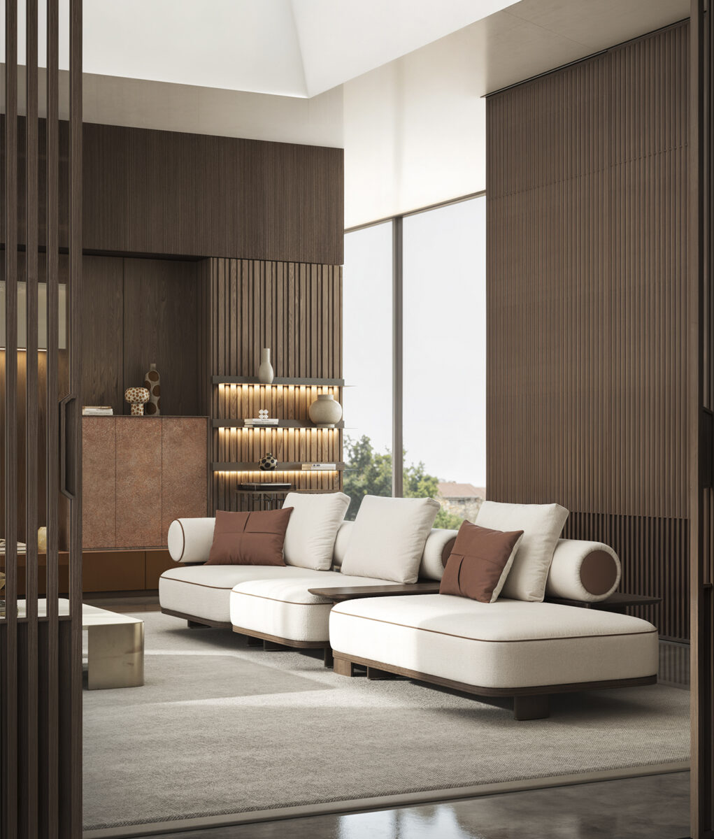 An elegant modern living room featuring a white sectional sofa with brown accent pillows, wooden wall panels, and large windows allowing natural light.