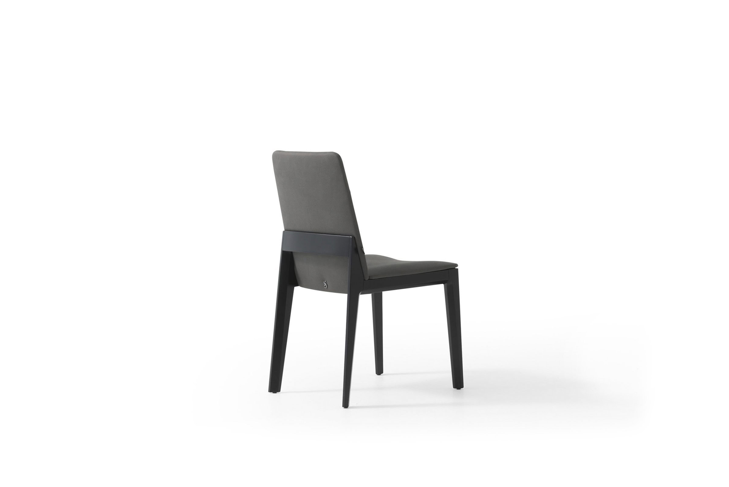 Modern grey upholstered dining chair with black wooden legs, perfect for contemporary kitchen and dining room interiors. Designed for comfort and style in elegant home settings.