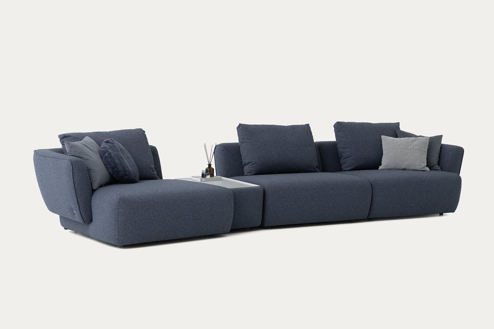 Elegant modern blue sectional sofa with multiple cushions, perfect for contemporary living room decor.