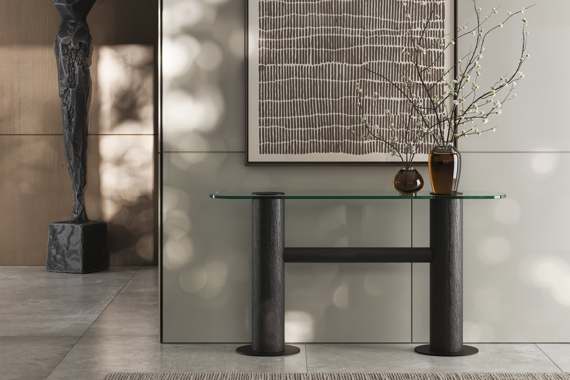 Elegant modern console table with glass top and black cylindrical legs, decorated with vases and branches, in a contemporary interior setting.