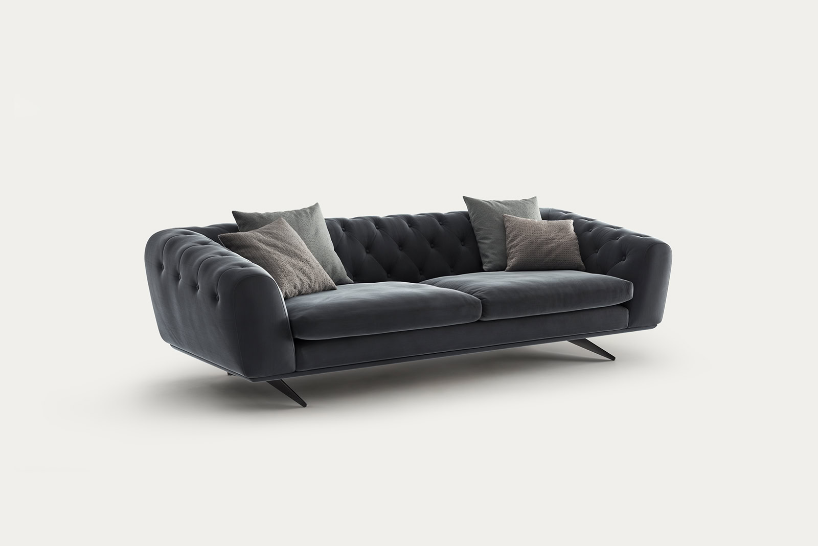 Stylish black velvet sofa with tufted design and four decorative pillows, perfect for contemporary home decor.
