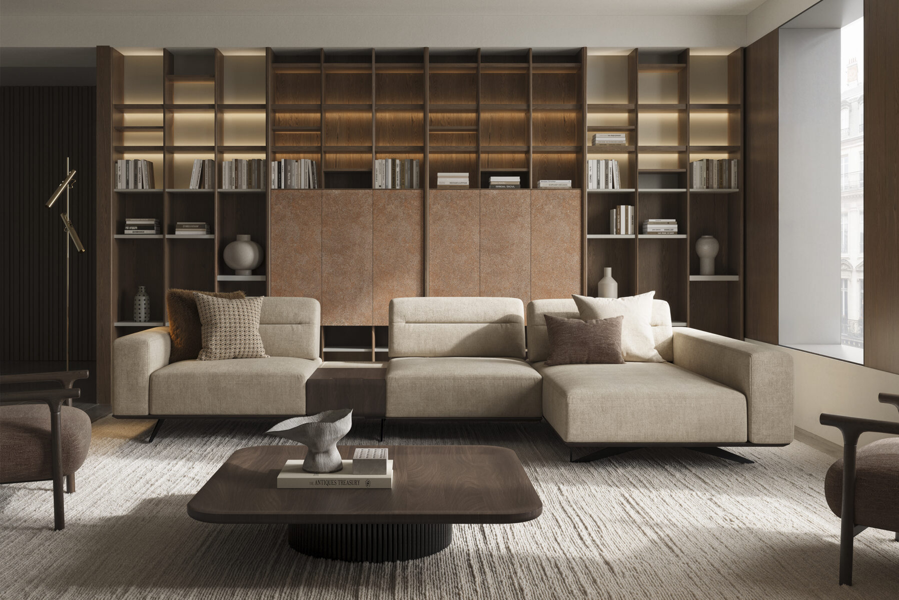 Elegant modern living room featuring a large beige sectional sofa, a wooden coffee table, and a custom-built bookshelf wall with ambient lighting.