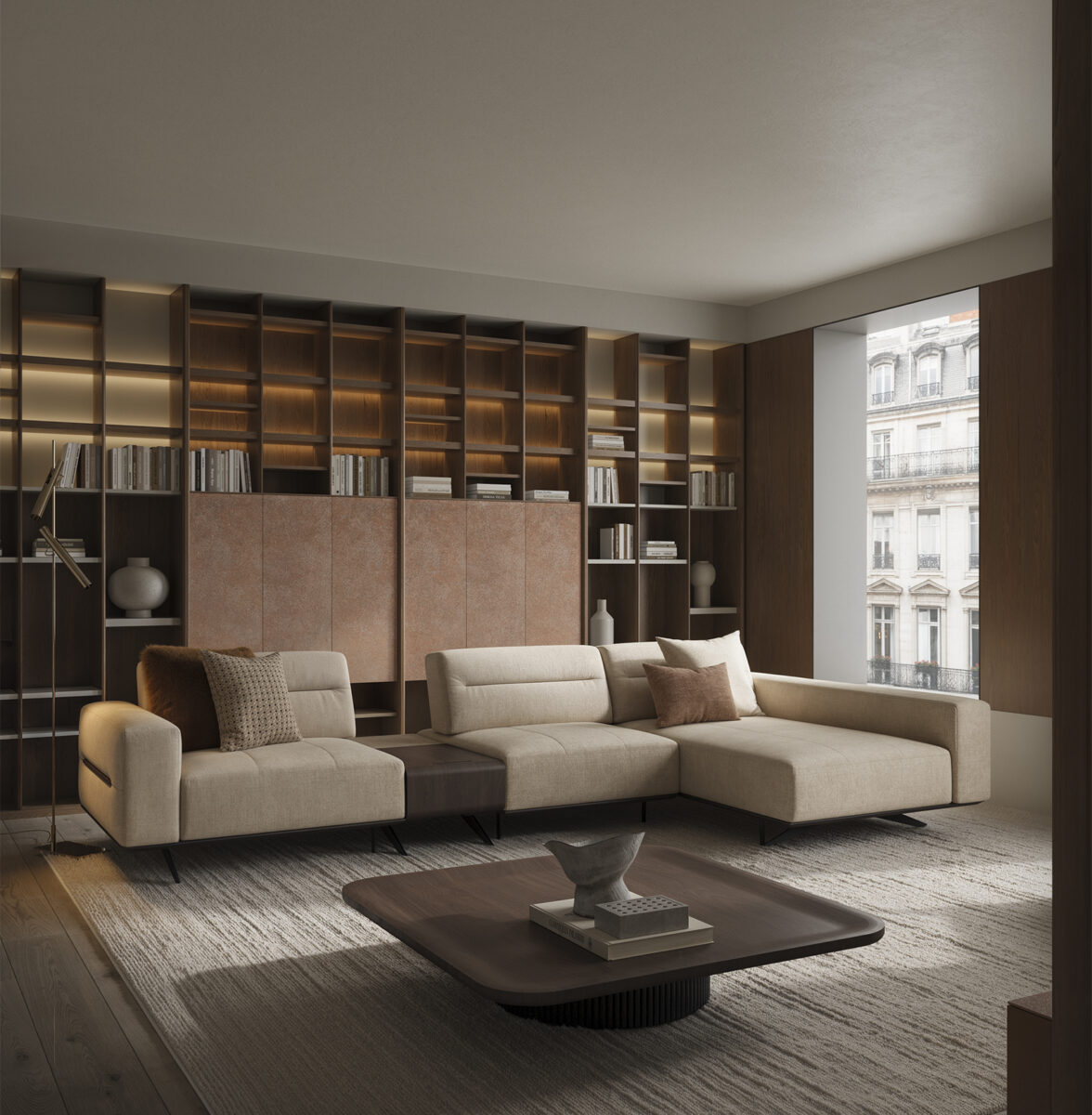 Elegant modern living room featuring a large beige sectional sofa, wooden bookshelf, and a coffee table, with natural light from large windows.