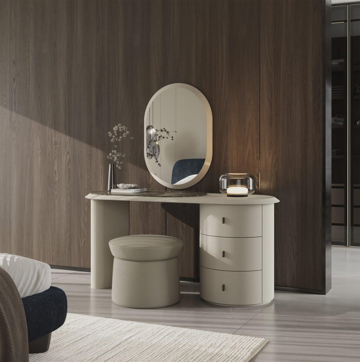 Elegant modern vanity table with oval mirror, beige stool, and decorative items in a stylish bedroom setting.