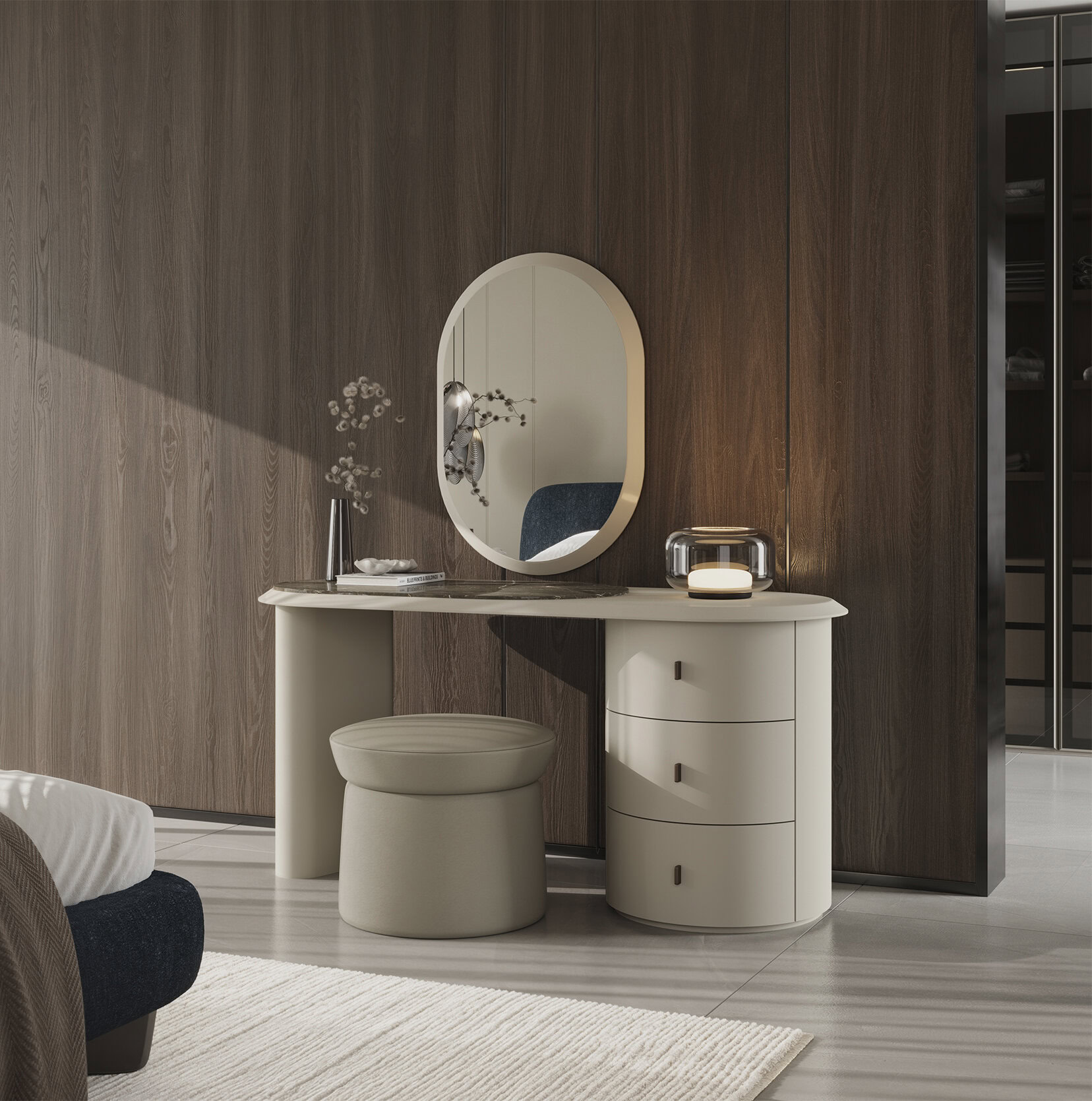 Elegant modern vanity table with oval mirror, beige stool, and decorative items in a stylish bedroom setting.