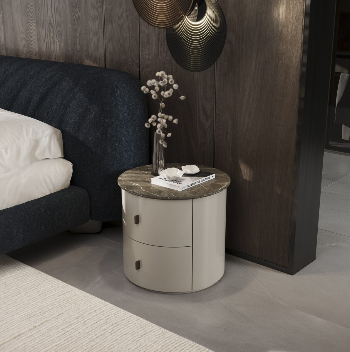 Contemporary round nightstand with a marble top, white finish, and two drawers, placed beside a bed with a dark headboard in a stylish bedroom.