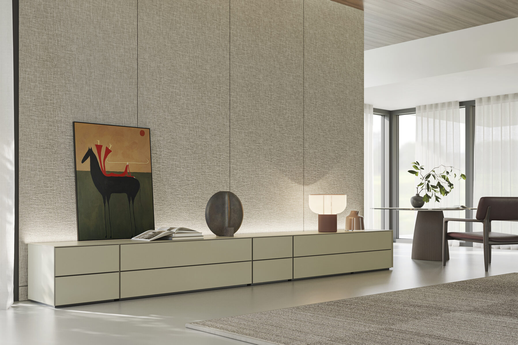 Contemporary minimalist living room with sleek white TV console, artistic decor, modern table lamp, and a cozy armchair in a bright space with large windows and sheer curtains.