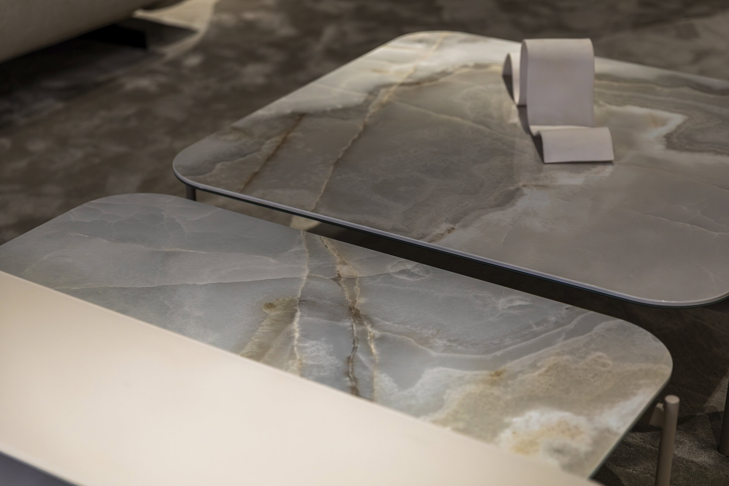 Set of modern marble coffee tables with sleek design and natural stone patterns, perfect for contemporary living spaces.