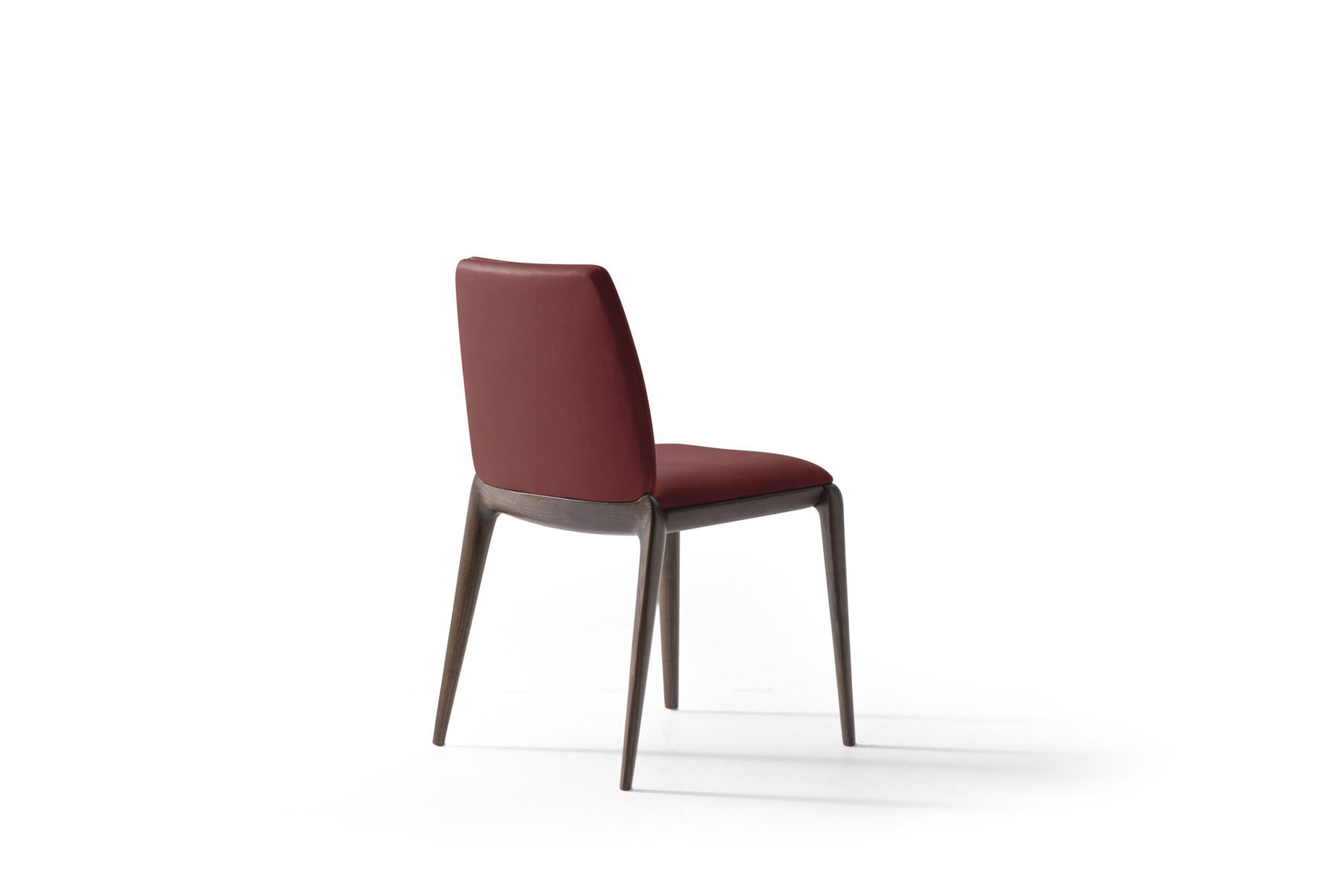 Elegant modern dining chair with a red upholstered seat and backrest, featuring sleek wooden legs, ideal for stylish home or restaurant interiors.