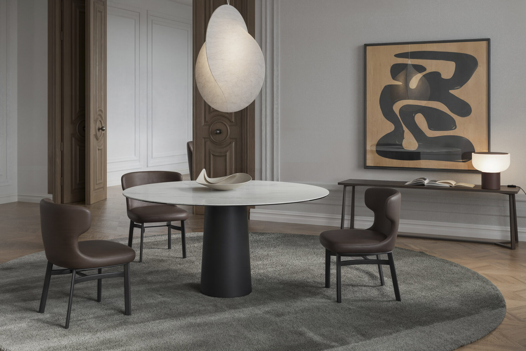 Elegant dining room featuring a round white table, four brown chairs, abstract wall art, and contemporary lighting, showcasing Saloni Furniture's stylish design.