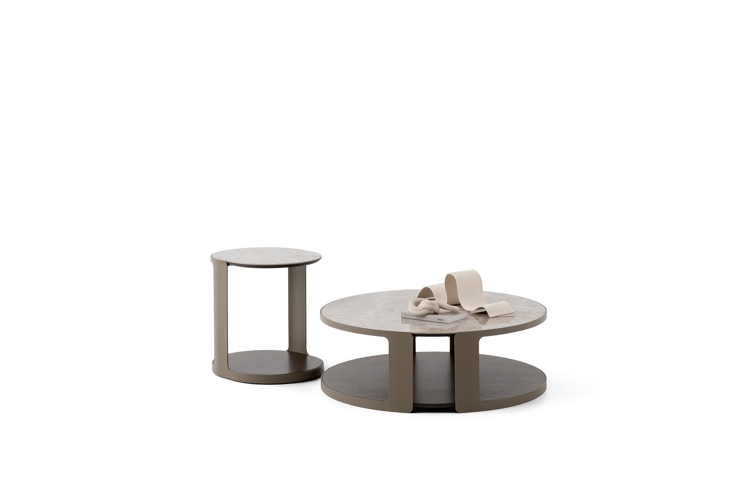 Set of two modern Saloni Furniture coffee tables with minimalist design, featuring round surfaces and neutral tones, ideal for contemporary living rooms.