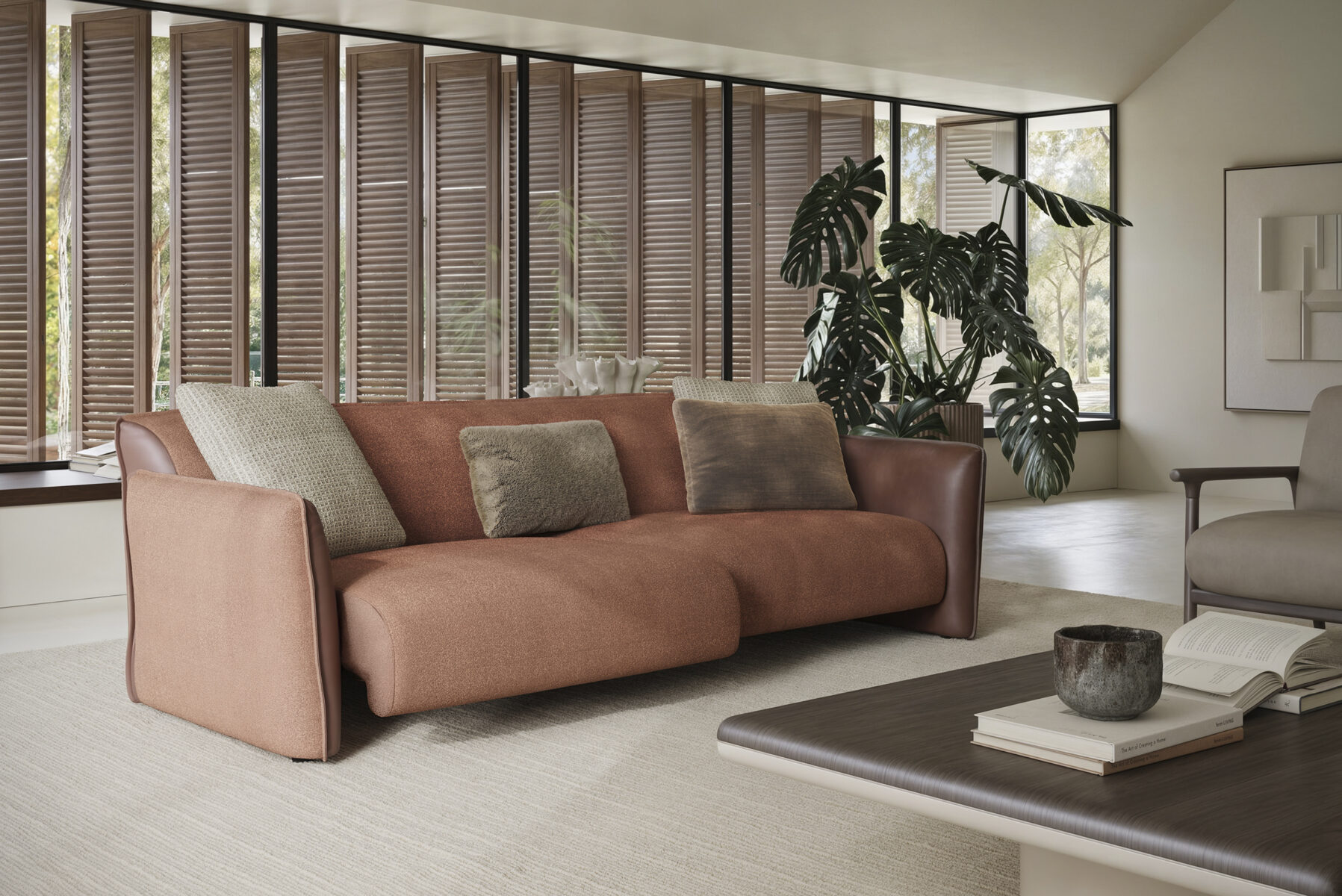 Elegant modern sofa with plush cushions in a contemporary living room setting, featuring natural light and stylish decor.