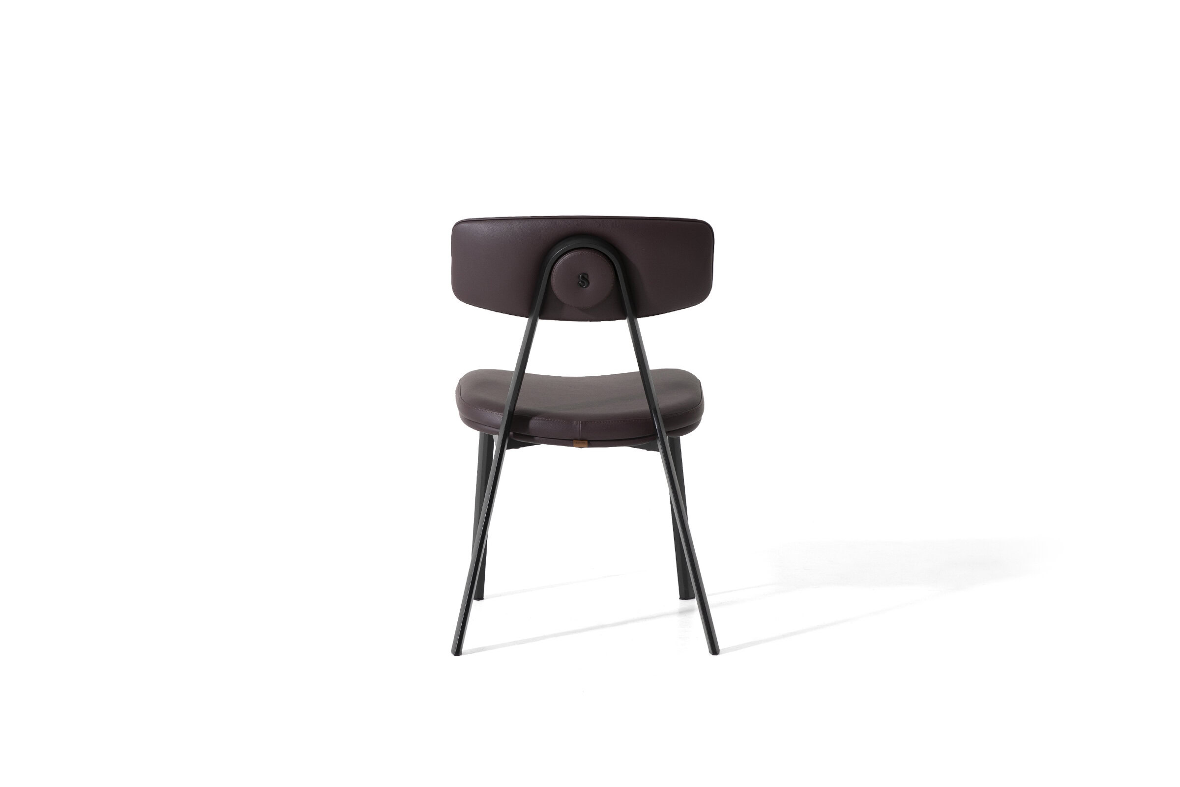 Sleek modern dining chair with leather upholstery and metal frame, perfect for contemporary home or office interiors. Stylish design combining comfort and elegance for versatile spaces.